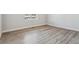 Empty bedroom featuring hardwood floors, natural light, trim, and neutral paint at 4334 Gozzer Ranch Dr, Elizabeth, CO 80107