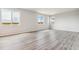 Open floor plan of a living room shows large windows, hardwood floors, and natural light at 4334 Gozzer Ranch Dr, Elizabeth, CO 80107