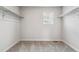 Bright walk-in closet featuring carpet, shelving, and a window for natural light at 4334 Gozzer Ranch Dr, Elizabeth, CO 80107