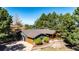 Stunning aerial view shows the home's setting surrounded by lush trees and well-maintained landscaping at 2231 Meadow Green Cir, Franktown, CO 80116