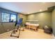 Spacious basement featuring an inversion table, massage table, and fitness equipment for a home gym at 2231 Meadow Green Cir, Franktown, CO 80116