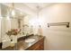 Bathroom with granite countertop, wood cabinets, decorative pendant lights, and shower with white subway tile at 2231 Meadow Green Cir, Franktown, CO 80116
