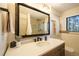 Bright bathroom featuring modern vanity with quartz countertop, chrome fixtures, and framed mirror at 2231 Meadow Green Cir, Franktown, CO 80116