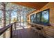 Inviting deck with bar seating, offering scenic views of the surrounding trees and landscape at 2231 Meadow Green Cir, Franktown, CO 80116