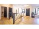 Bright entryway boasts modern railing and beautiful hardwood floors, creating a stylish first impression at 2231 Meadow Green Cir, Franktown, CO 80116