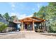 Inviting home features a cozy wood porch and stone accents, creating a warm and welcoming entrance at 2231 Meadow Green Cir, Franktown, CO 80116