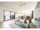 Bright living room offers a seamless transition to the outdoor patio through large sliding glass doors at 2231 Meadow Green Cir, Franktown, CO 80116