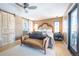 Spacious main bedroom featuring barn door, ceiling fan, and a cozy sitting area at 2231 Meadow Green Cir, Franktown, CO 80116