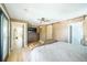 Bright main bedroom boasts light wood floors, ceiling fan, and ensuite bathroom at 2231 Meadow Green Cir, Franktown, CO 80116