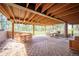 Covered patio with ample seating options, overlooking lush greenery and natural surroundings at 2231 Meadow Green Cir, Franktown, CO 80116