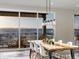 Bright dining area featuring a wooden table, modern chairs, and sliding glass doors leading to a deck at 730 Edenborn Pl, Castle Rock, CO 80104