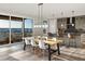 Well-lit dining area with a large table, modern chairs, and access to a deck with scenic views at 730 Edenborn Pl, Castle Rock, CO 80104