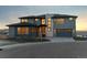 Stunning two-story home boasts a three-car garage, stone accents, and manicured landscaping for curb appeal at 730 Edenborn Pl, Castle Rock, CO 80104