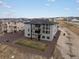 Rear view of a gray two-story home featuring a balcony, neutral landscaping, and large windows at 730 Edenborn Pl, Castle Rock, CO 80104
