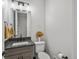 Stylish half bathroom with modern fixtures, a gray vanity, and decorative accents at 730 Edenborn Pl, Castle Rock, CO 80104