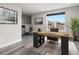 Bright home office with a large window, modern desk, stylish decor and neutral colors at 730 Edenborn Pl, Castle Rock, CO 80104