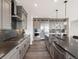 Stylish kitchen with stainless steel appliances, gray cabinetry, and a spacious center island at 730 Edenborn Pl, Castle Rock, CO 80104