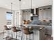 Modern kitchen featuring a large island with seating, sleek countertops, and stainless steel appliances at 730 Edenborn Pl, Castle Rock, CO 80104