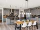 Modern eat-in kitchen with stainless steel appliances, gray cabinetry, central island and wood dining table at 730 Edenborn Pl, Castle Rock, CO 80104