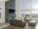 Bright living room with a stone fireplace, large windows, and comfortable seating at 730 Edenborn Pl, Castle Rock, CO 80104