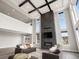 Impressive living room featuring tall ceilings, a fireplace, and abundant natural light from expansive windows at 730 Edenborn Pl, Castle Rock, CO 80104