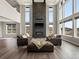 Bright living room boasts soaring ceilings, a modern fireplace, and plenty of natural light from large windows at 730 Edenborn Pl, Castle Rock, CO 80104