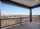 Spacious patio with scenic views, a stylish railing and wood-look flooring at 730 Edenborn Pl, Castle Rock, CO 80104