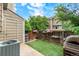 Landscaped backyard features artificial turf, a grill, storage shed and a wood fence at 9632 W Chatfield Ave # C, Littleton, CO 80128
