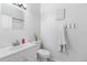 Clean bathroom with a sink, toilet, and a 