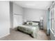 Well lit bedroom with a skylight, neutral carpet, and a view of the outside at 9632 W Chatfield Ave # C, Littleton, CO 80128