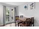 Dining area with a wood table, seating for four, and a French door to the backyard at 9632 W Chatfield Ave # C, Littleton, CO 80128