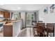 Dining area adjacent to kitchen features a window, a wood dining table, and outdoor access at 9632 W Chatfield Ave # C, Littleton, CO 80128