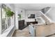 Bright living room with a fireplace, staircase, and modern décor, creating a welcoming atmosphere at 9632 W Chatfield Ave # C, Littleton, CO 80128