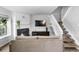 Stylish living room with a fireplace, stairs, and natural light, perfect for relaxation and entertaining at 9632 W Chatfield Ave # C, Littleton, CO 80128