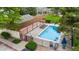 Aerial view of the neighborhood pool with lounge chairs and umbrellas in a fenced in area at 9632 W Chatfield Ave # C, Littleton, CO 80128