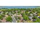 Scenic aerial view of neighborhood condos surrounded by mature trees, city streets, and a scenic lake at 9587 W 89Th Cir, Broomfield, CO 80021