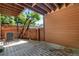 Enclosed patio area with wooden fence and exposed wood under structure at 9587 W 89Th Cir, Broomfield, CO 80021