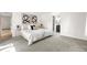 Spacious bedroom with plush carpets, neutral decor, and ensuite bathroom entrance at 9587 W 89Th Cir, Broomfield, CO 80021