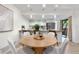 Open dining area with modern lighting, flowing seamlessly into the kitchen with stainless steel appliances at 9587 W 89Th Cir, Broomfield, CO 80021