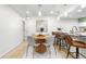 Well-lit dining area features a modern chandelier and a round wood table for Gathering meals at 9587 W 89Th Cir, Broomfield, CO 80021