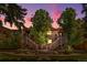 Exterior view of a townhouse complex at dusk, showing well-maintained landscaping at 9587 W 89Th Cir, Broomfield, CO 80021