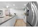 Bright open kitchen features stainless steel appliances, modern countertops, and sleek cabinetry at 9587 W 89Th Cir, Broomfield, CO 80021