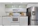 Well-lit kitchen showcases stainless steel appliances and light cabinets with modern countertops at 9587 W 89Th Cir, Broomfield, CO 80021