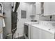 Functional laundry area with washer, dryer, and storage cabinets at 9587 W 89Th Cir, Broomfield, CO 80021