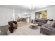 Open-concept living room flowing into a dining area, with a modern color palette and hardwood flooring at 9587 W 89Th Cir, Broomfield, CO 80021