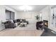 Cozy living room featuring a plush gray sectional, unique fireplace, and light wood floors at 9587 W 89Th Cir, Broomfield, CO 80021