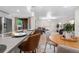 Open-concept living space with modern furnishings, hardwood floors, and access to a patio at 9587 W 89Th Cir, Broomfield, CO 80021