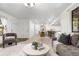 Spacious living area with a view of the kitchen and dining space, perfect for entertaining at 9587 W 89Th Cir, Broomfield, CO 80021