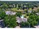 Expansive aerial view of a property featuring a pool, solar panels, and lush greenery in a neighborhood setting at 1 Silver Fox Dr, Greenwood Village, CO 80121