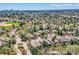 Neighborhood aerial view with green trees and glimpses of houses with tile roofs at 1 Silver Fox Dr, Greenwood Village, CO 80121
